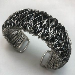 Bracelet with black beads and silver wire.